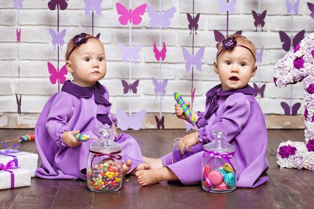 Cute twin sisters celebrating their 1th birthday