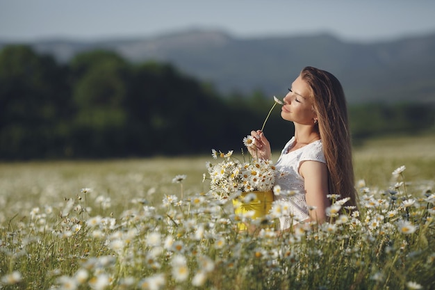 cute woman in camomile field