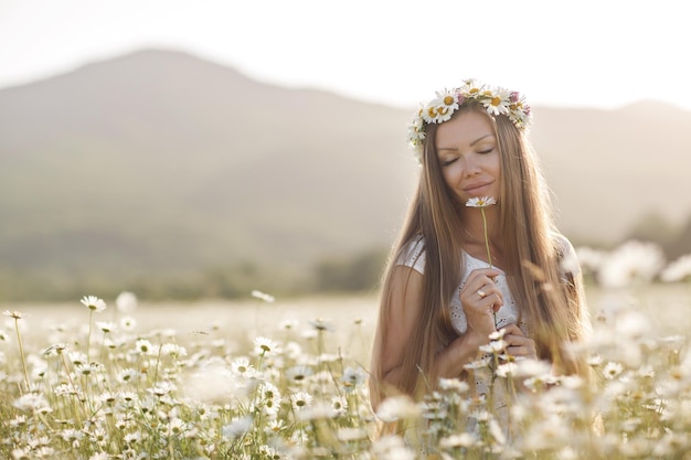 cute woman in camomile field