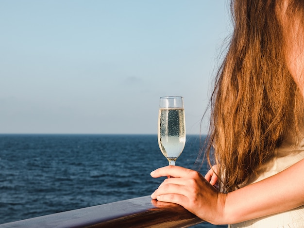 Cute woman holding a beautiful glass of champagne