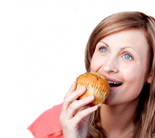 Cute woman is eating a cake