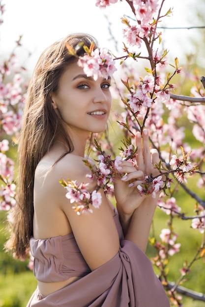 cute woman near blossom tree