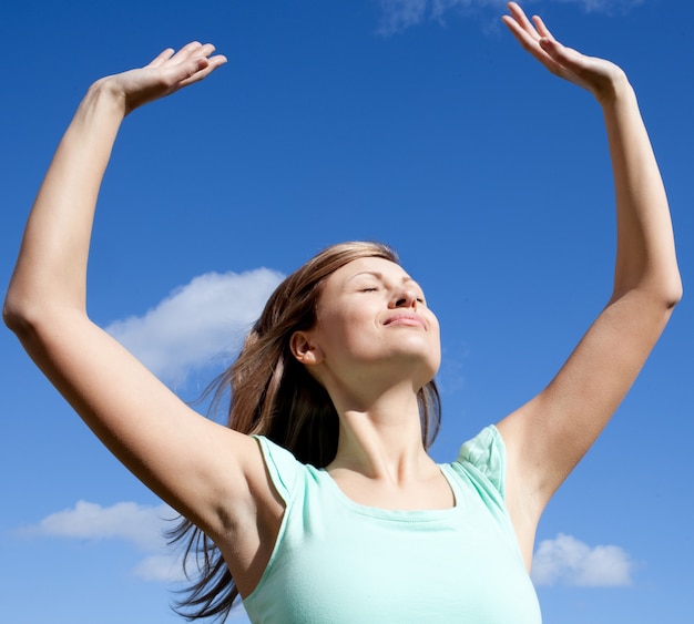 Cute woman punching the air outdoor 