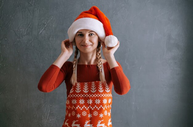 Cute woman putting on santa hat