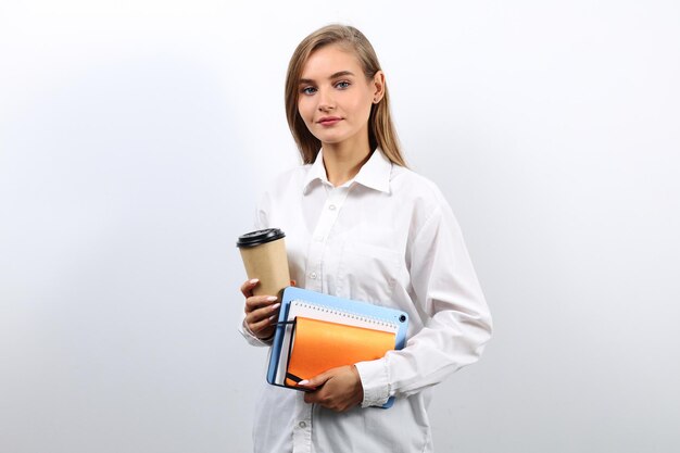 Photo cute woman secretary with brown hair holding a tablet and a cup of coffee