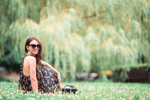 Cute woman sitting in the park.