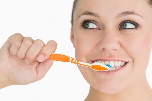 Cute woman washing her teeth