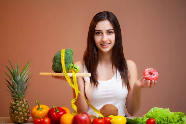 Cute woman with fresh vegetables and fruits leading a healthy lifestyle