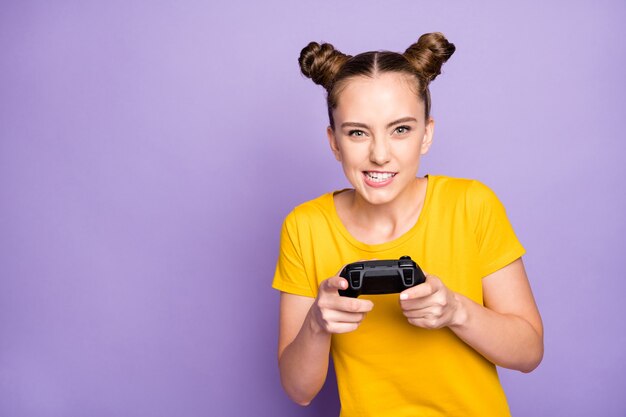 Cute woman with topknots posing against the purple wall