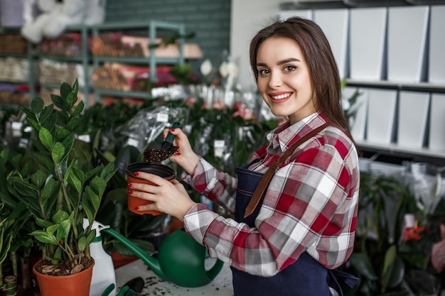 Cute woman working in flower center