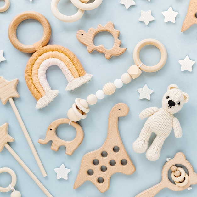 Cute wooden baby toys. Knitted bear, rainbow, dinosaur toy, beads and stars.