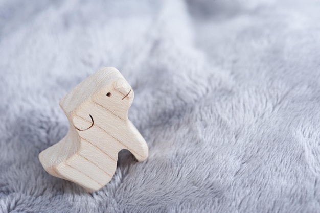 Cute wooden toy animals on fluffy fabric