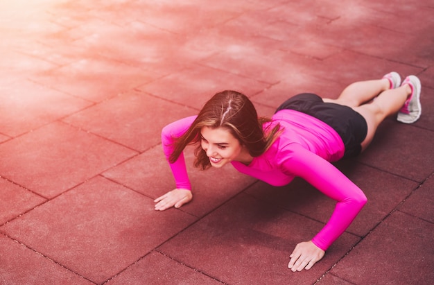 Cute young brunette sporty girl workout outdoor