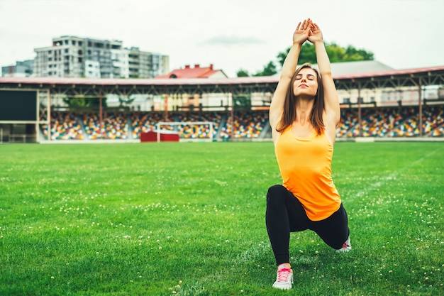 Cute young brunette sporty girl workout outdoor