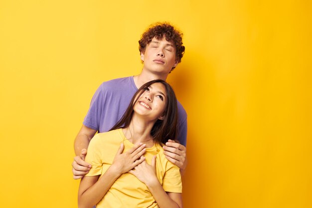 Cute young couple in colorful tshirts posing friendship fun isolated background unaltered