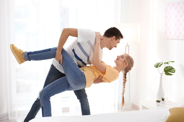 Cute young couple dancing indoors