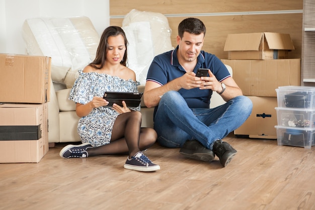 Cute young couple in their new house. Relaxing in new apartment