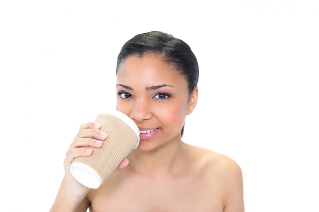 Cute young dark haired model drinking coffee