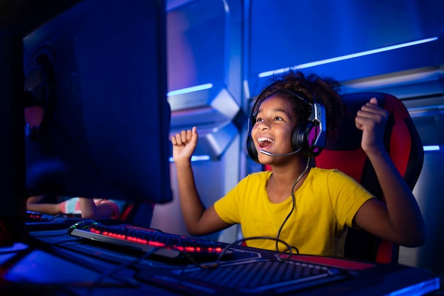 Cute young girl feeling happy and excited for winning computer video game