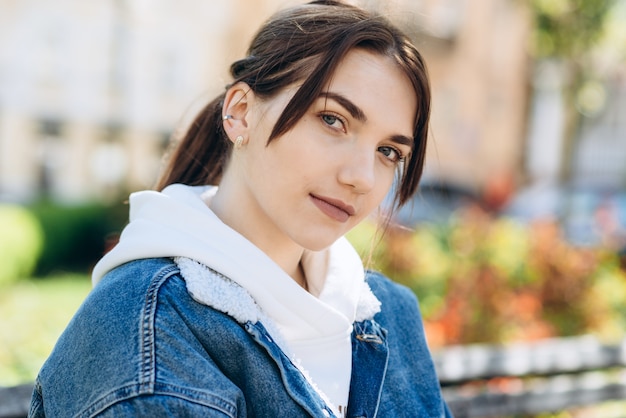 Cute, young girl looking at the camera, outdoors