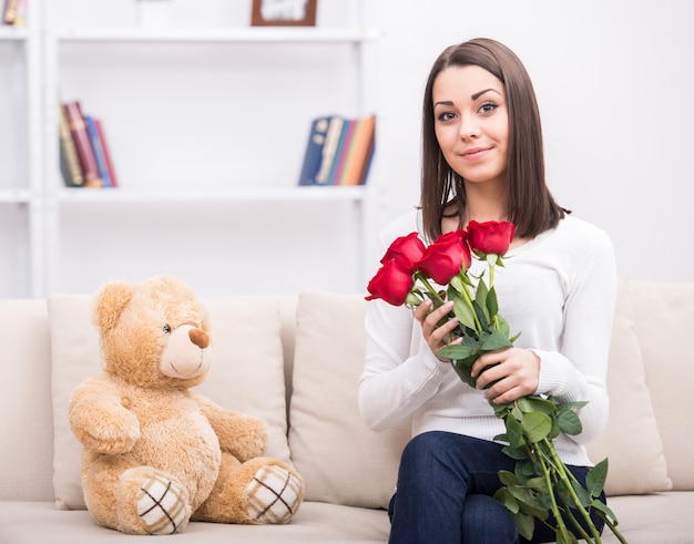 cute young girl with flowers at home.