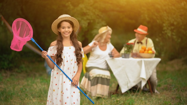 Cute Young Girl With A Pink Butterfly Net