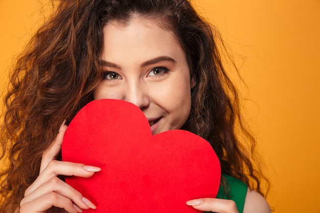 Photo cute young lady holding heart.