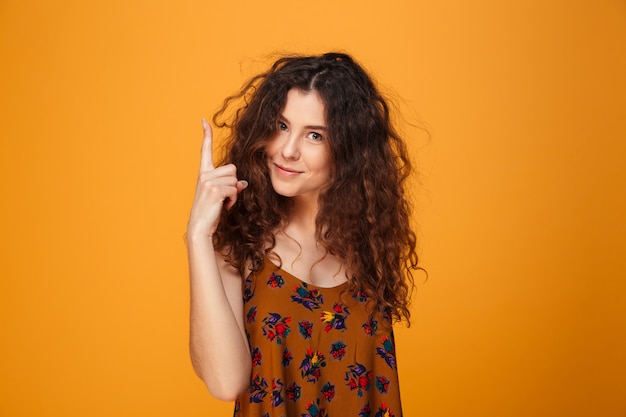 Cute young lady pointing.