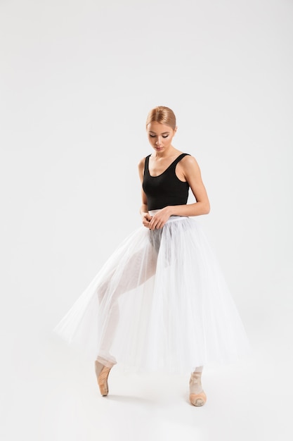 Cute young woman ballerina dancing gracefully