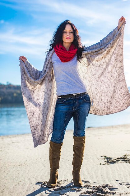 Cute young woman at the beach at winter