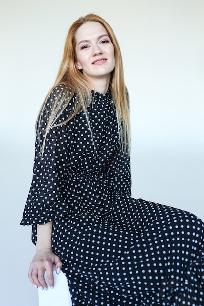 Cute young woman in black polka dot dress