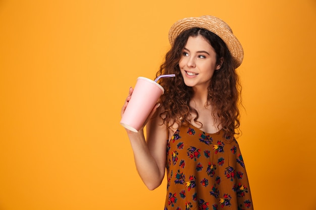 Cute young woman drinking aerated sweet water.