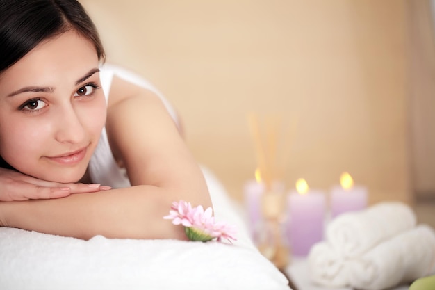 Cute young woman enjoying during a skin care treatment at a spa.