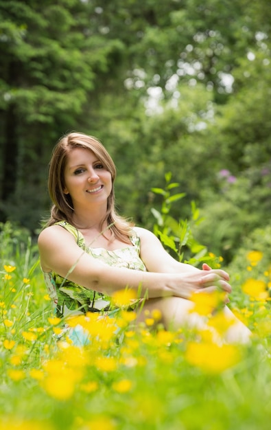 Cute young woman relaxing in field