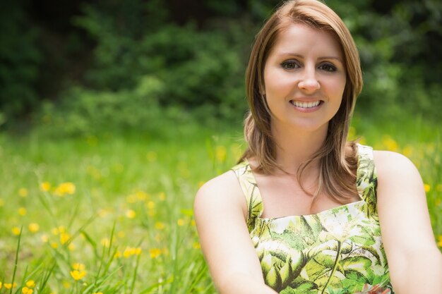 Cute young woman relaxing in field