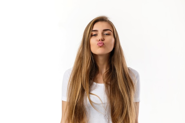 Cute young woman sending kiss