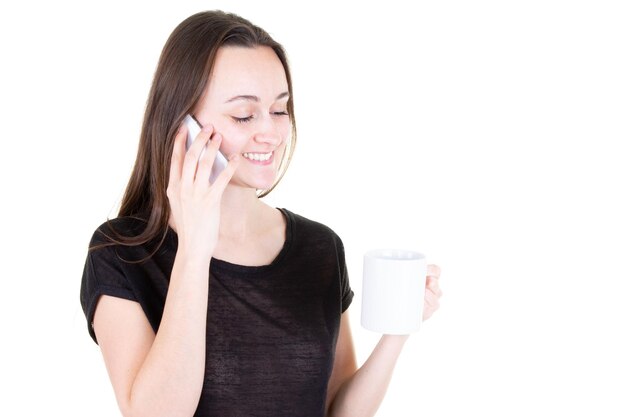 Cute young woman talking using phone and drinking coffee