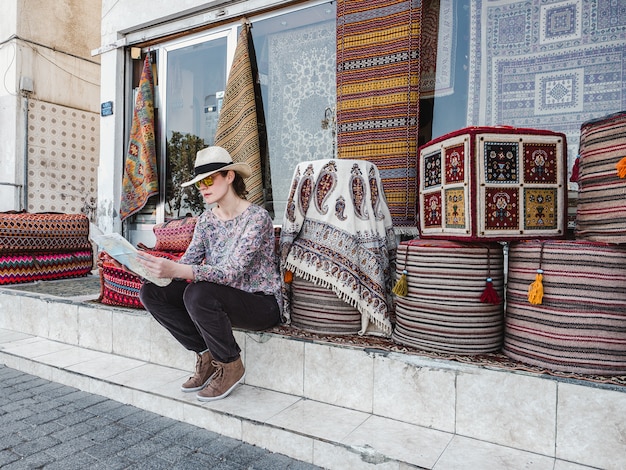 Cute, young woman with a tourist map