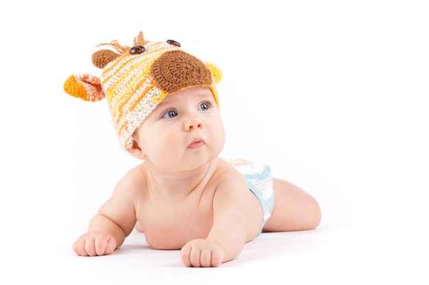 Cutie little boy in white diaper and deer hat