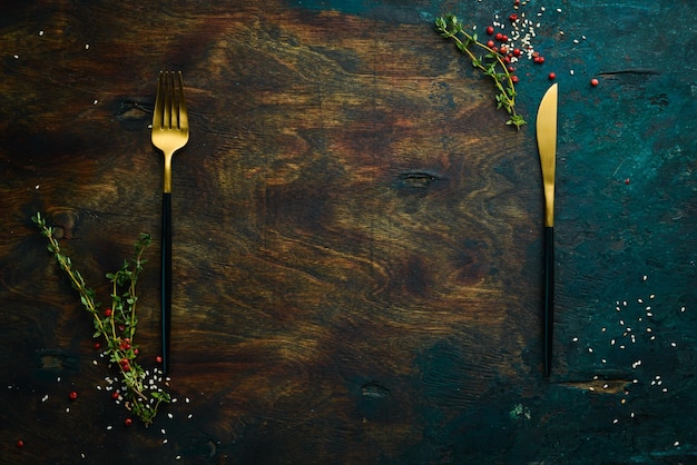 Photo cutlery on a dark wooden kitchen table top view free space for your text