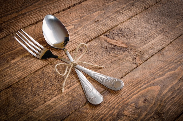 cutlery fork and spoon on a wooden background