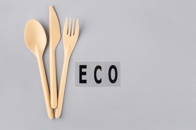 cutlery made of ecofriendly plastic on a gray background