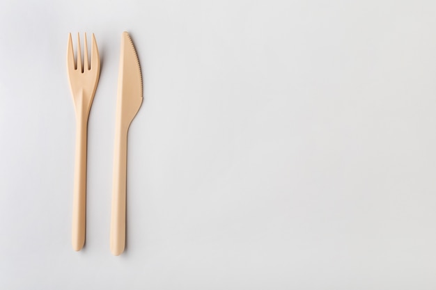 cutlery made of ecofriendly plastic on a gray solid background