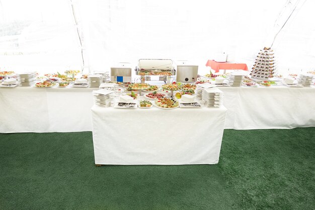 Photo cutlery and various dishes on the handout table in the restaurant