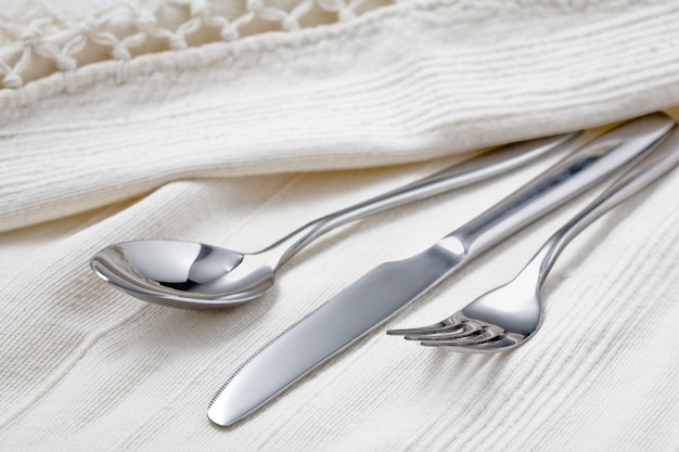 Cutlery on a white tablecloth