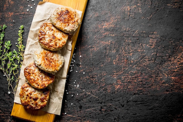 Cutlets on paper with thyme