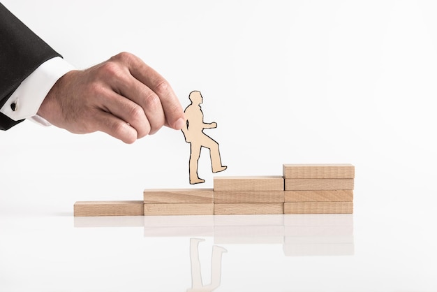 Cutout of a businessman walking up steps