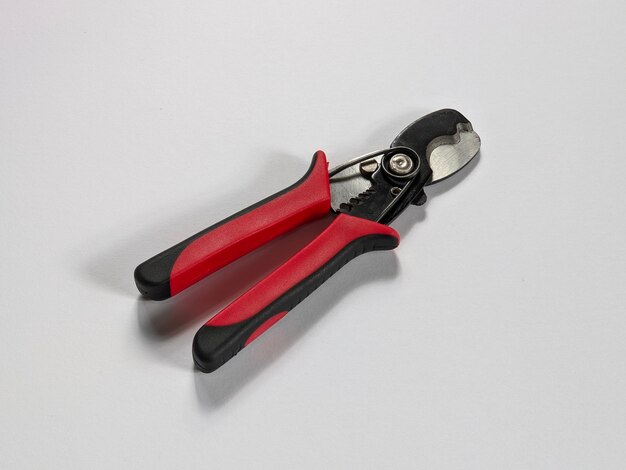 A cutter with red handles and black handles