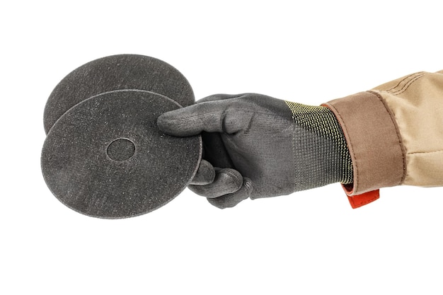 Cutting abrasive discs for angle grinder in worker hand in black protective glove isolated on white