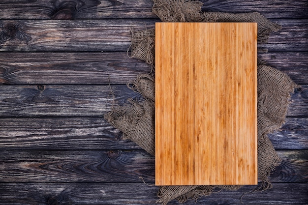 Photo cutting board on dark wood, top view